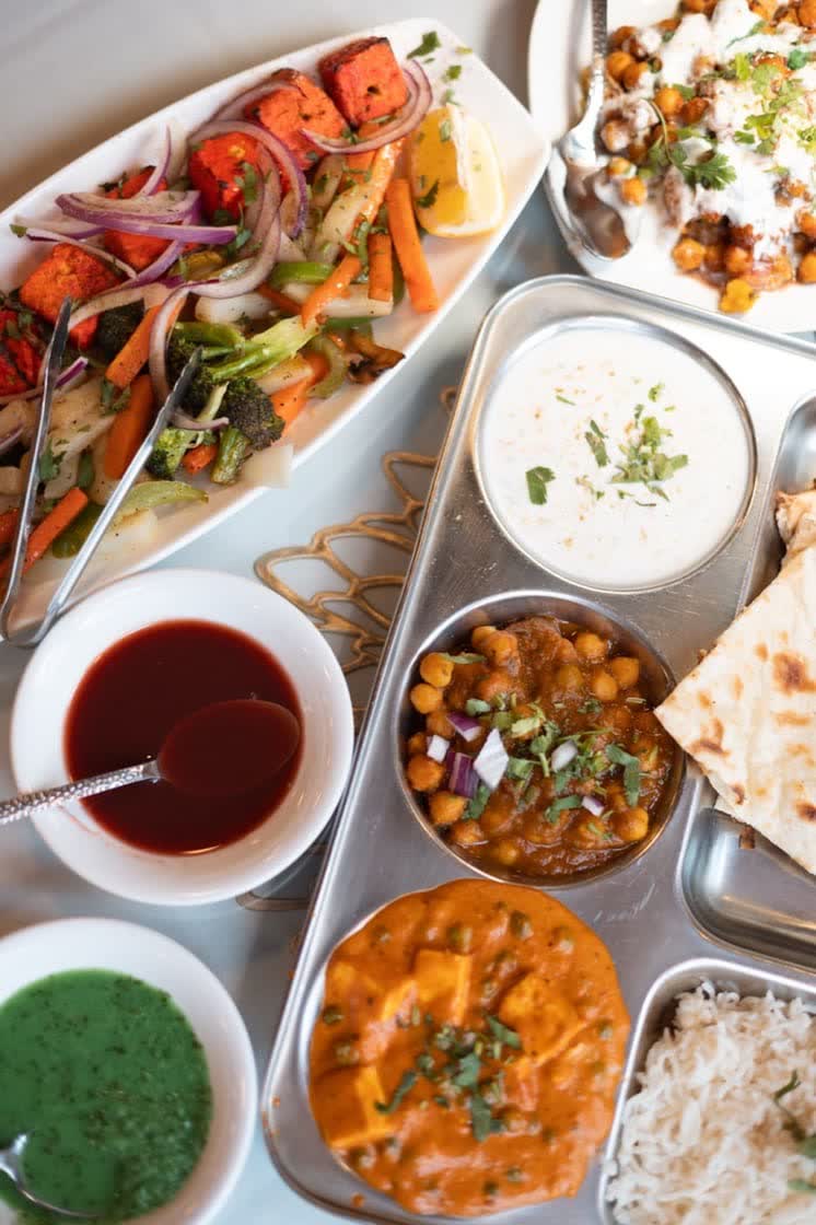 An Indian thali tray with each dish kept in its own compartment